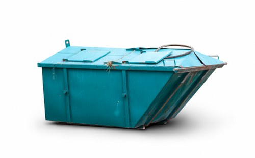 A large, teal-colored industrial waste container with a solid metal structure and textured finish sits on a flat surface, likely pavement or concrete, with its lid securely closed. The container features visible hinges and locking mechanisms, and a thick, black cable or hose drapes over the top, suggesting it may be used in waste management or removal tasks. The background is plain and white, placing full focus on the container without environmental context. The overall appearance indicates a durable, heavy-duty bin suitable for commercial rubbish removal, consistent with services provided by Business Waste Removal Fulham. This image exemplifies the type of refuse receptacles commonly used in urban environments around Fulham postcodes, where waste collection services handle various types of industrial or business rubbish. The container’s design emphasizes practicality and resilience, aligning with professional waste management operations in London residential and commercial districts.